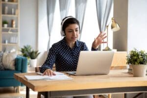 Young woman with headphones on working from home