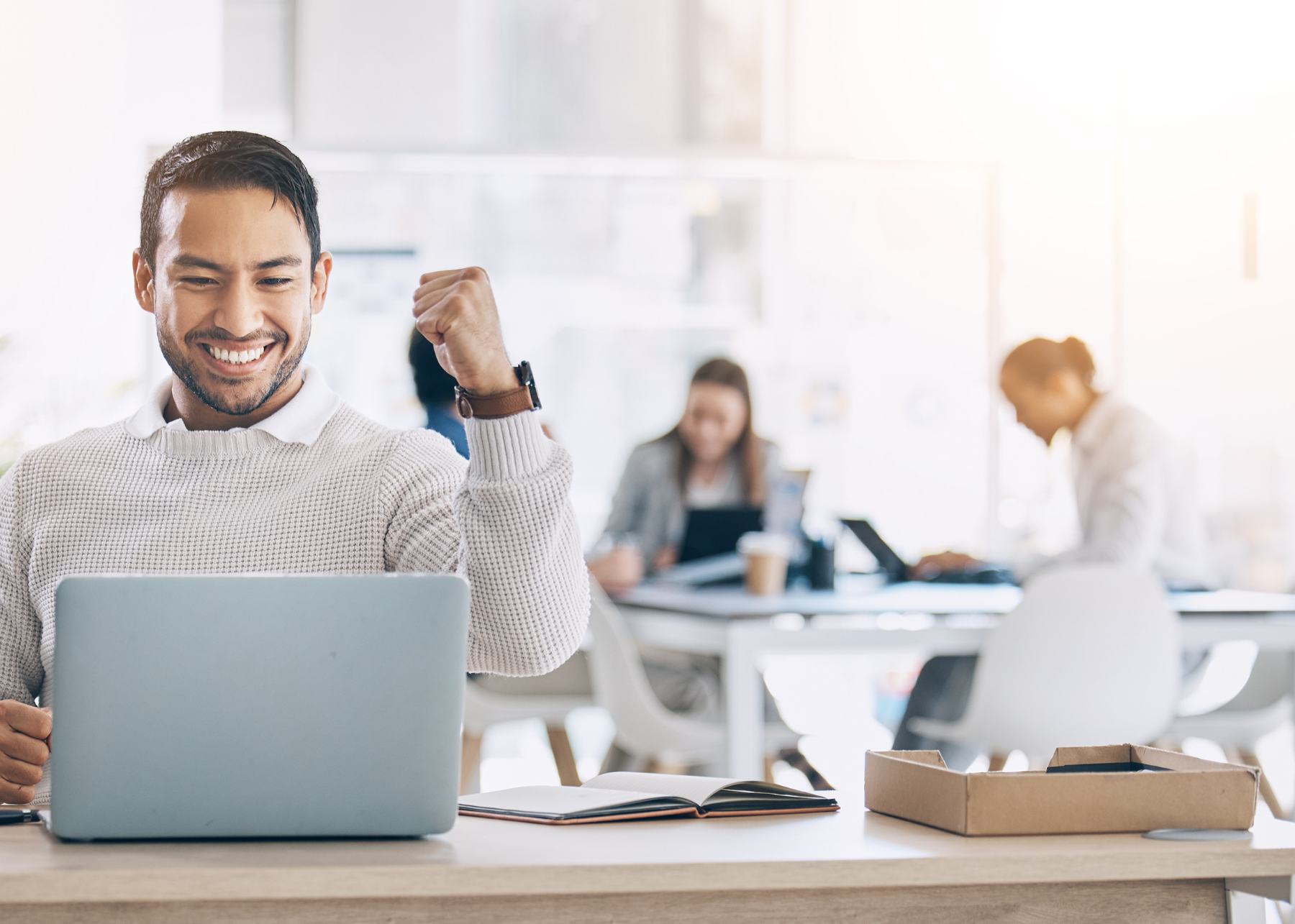 Men with grey sweater using computer happy and celebrating