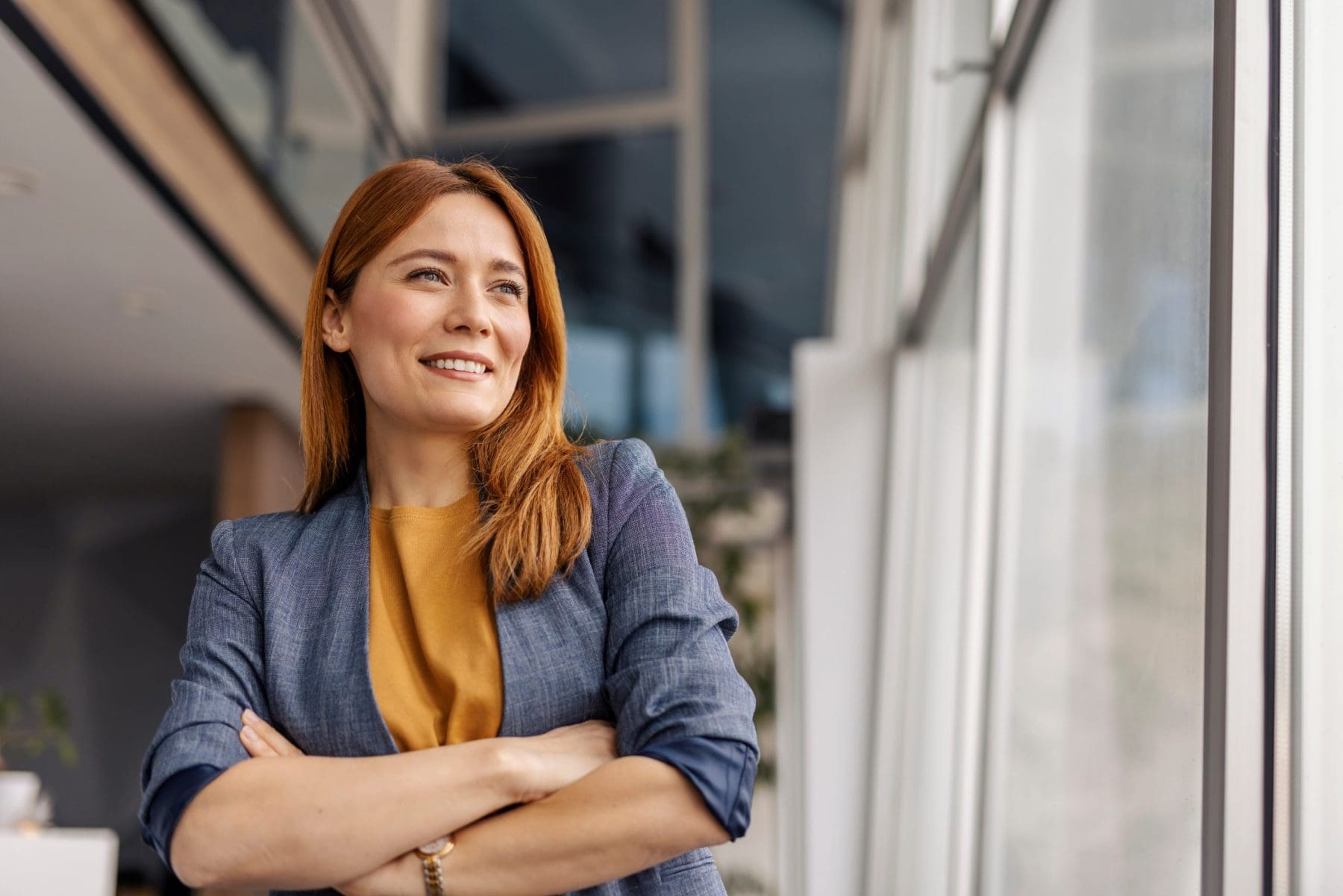 Portrait of smiling successful woman standing at corporate office
