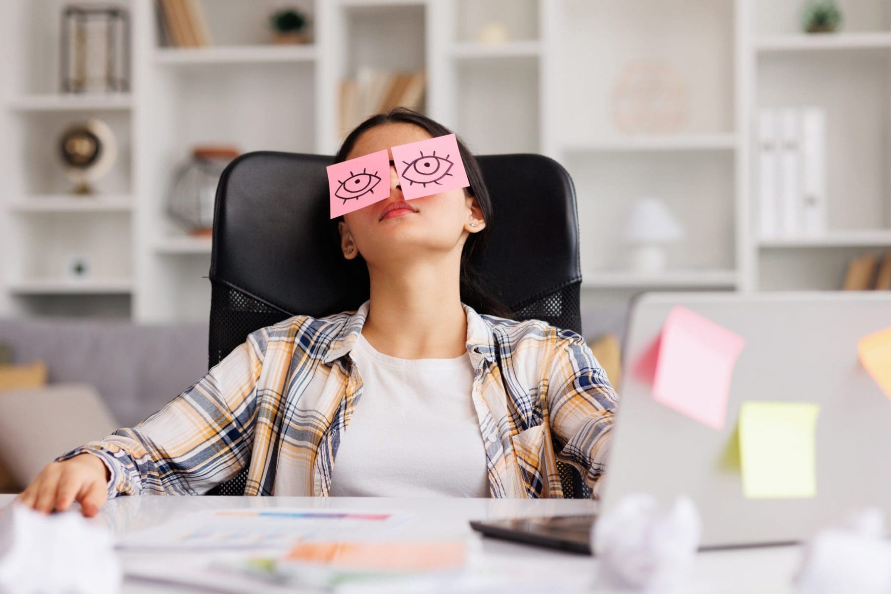 The concept of a lot of work. Tired girl sleeping with stickers on her eyes.
