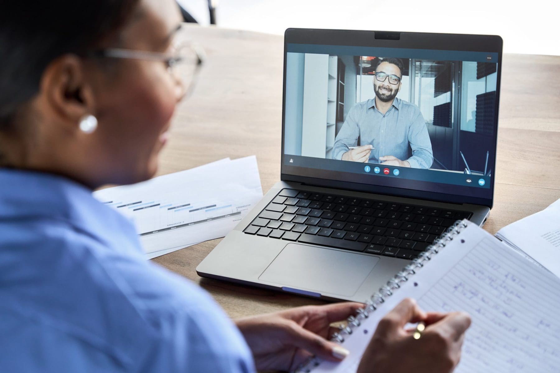 Woman working on laptop having video conference call.