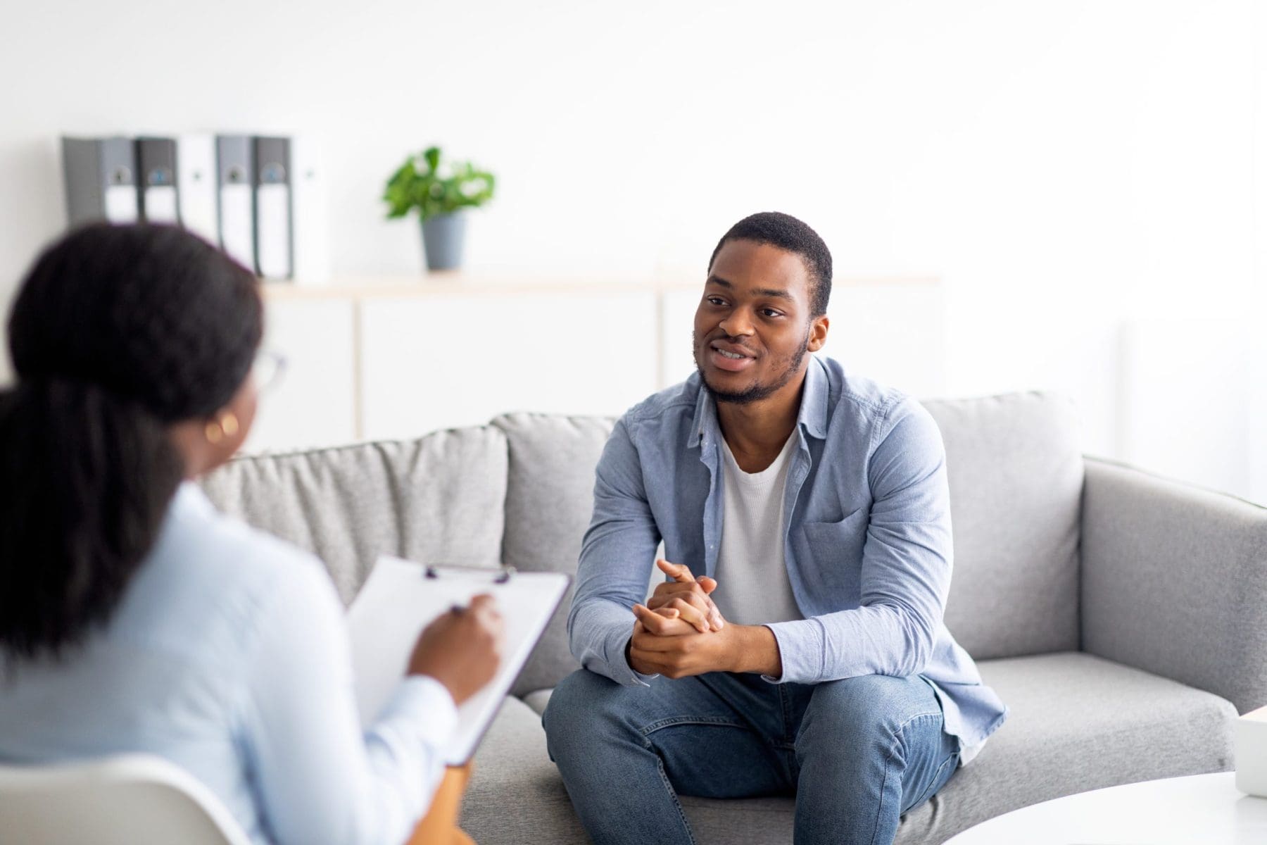 Young black guy talking to his psychologist,