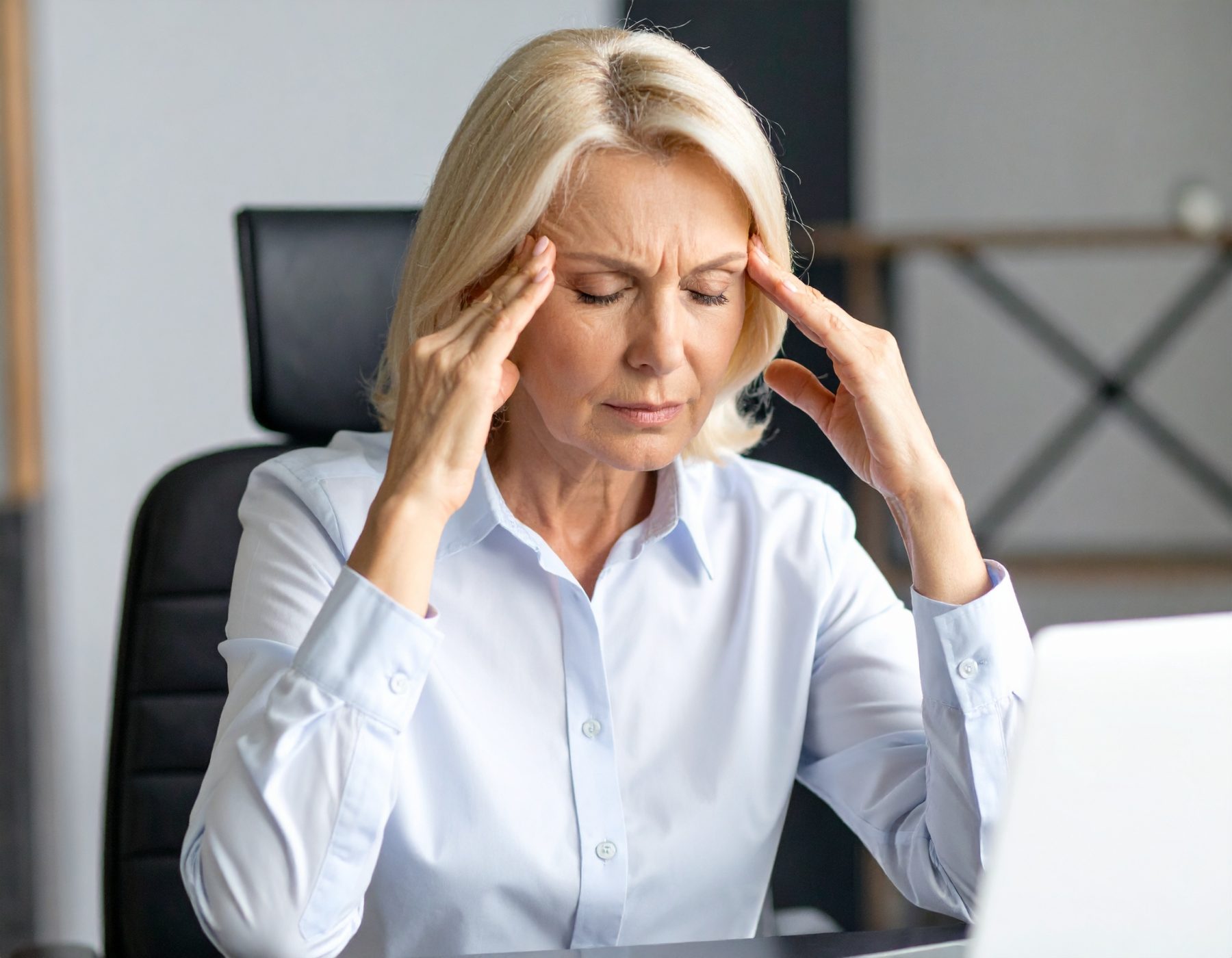 Exhausted professional woman showing signs of burnout and weariness.