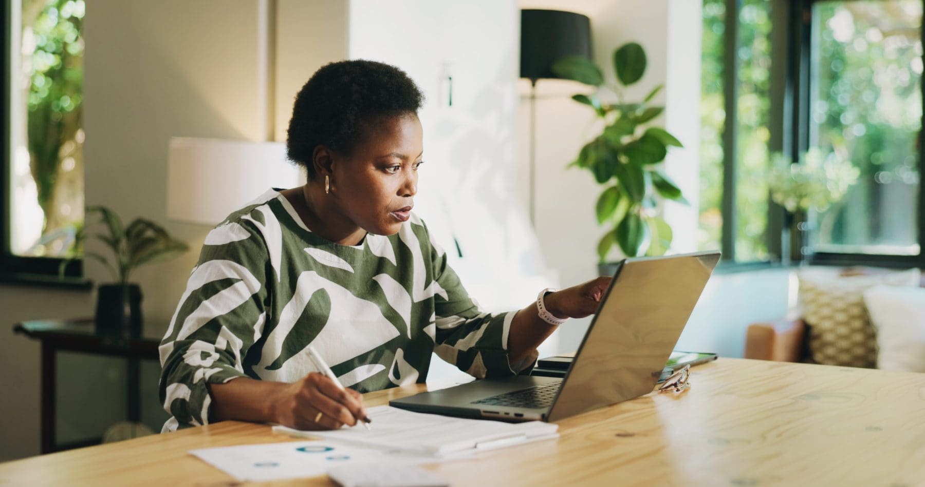 Woman with laptop in home.