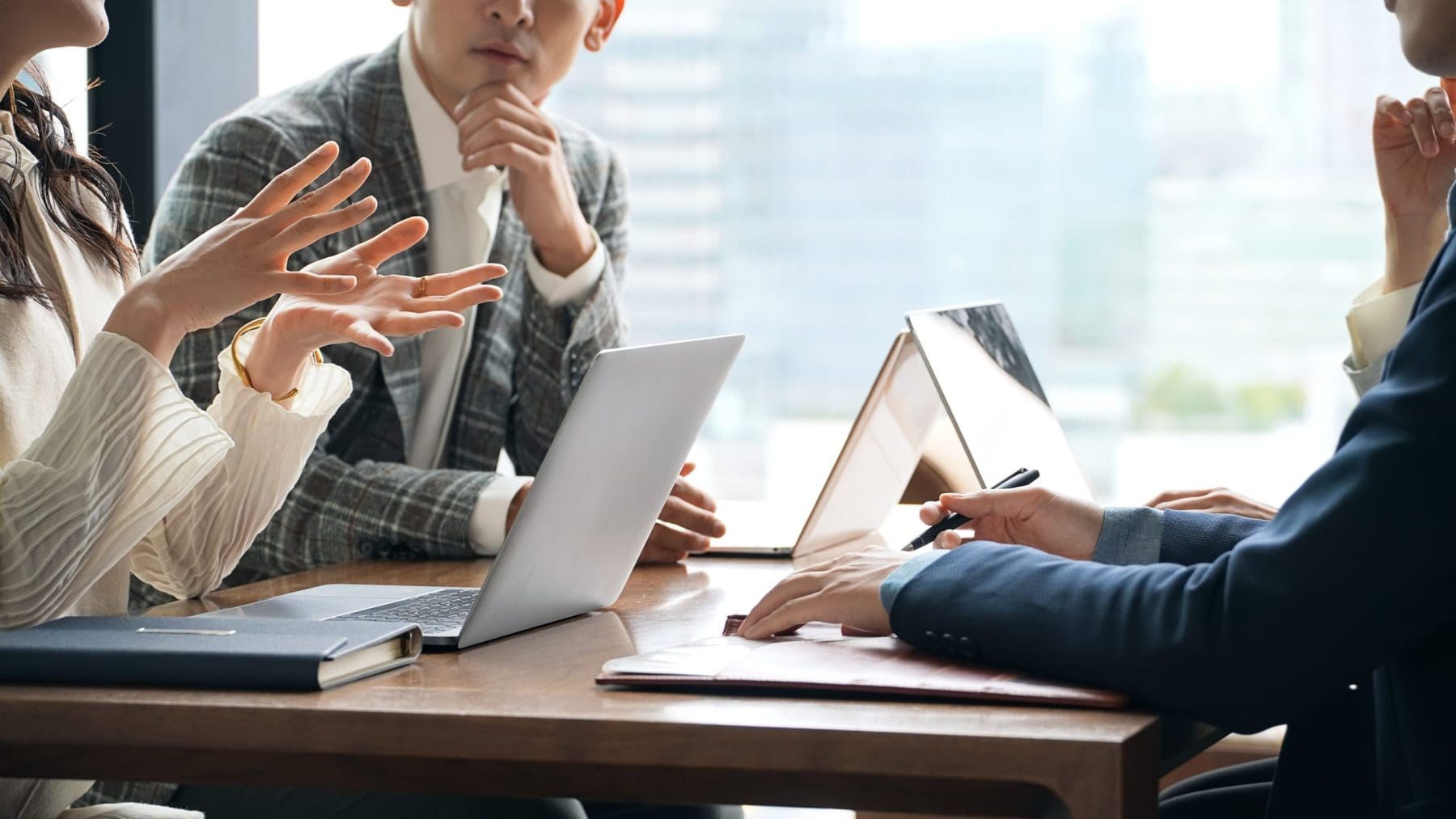 Group of casual business people meeting in an office.