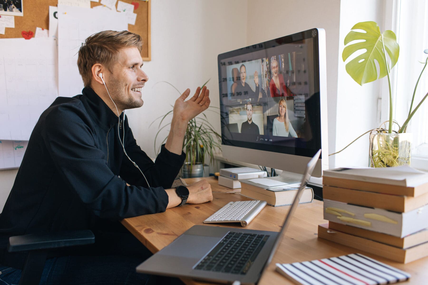 Young man having Zoom video call via a computer in the home office.