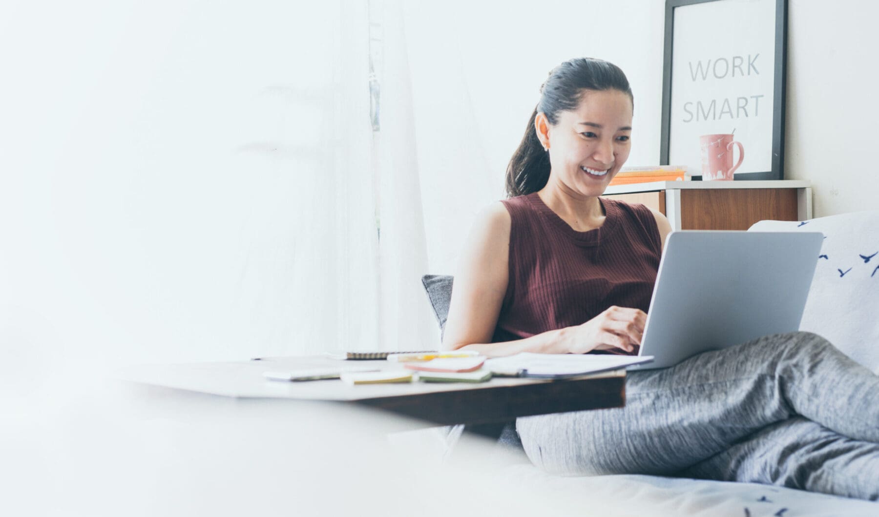 Work from home. Using computer while sitting on couch.