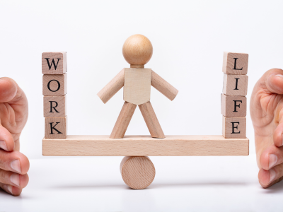 Wooden toy with human figure balancing work and life.