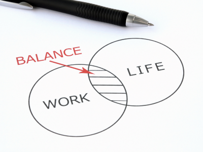 Two circle collide with words work and life on each. On the center word balance.