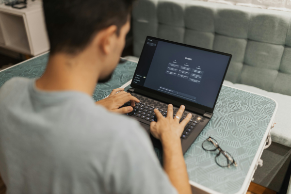 Man using laptop with AI chatbot.