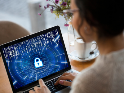 Woman using laptop with lock on screen.