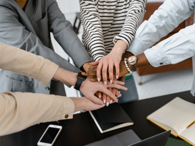 Woman touching hands in circle. Representing team work.